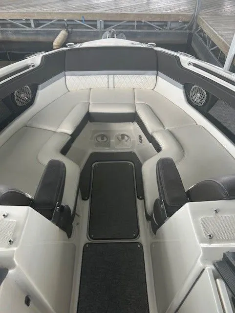 Slide: The Image of 2017 Sea Ray SLX 280 boat interior with cushioned seating and cup holders. - 4
