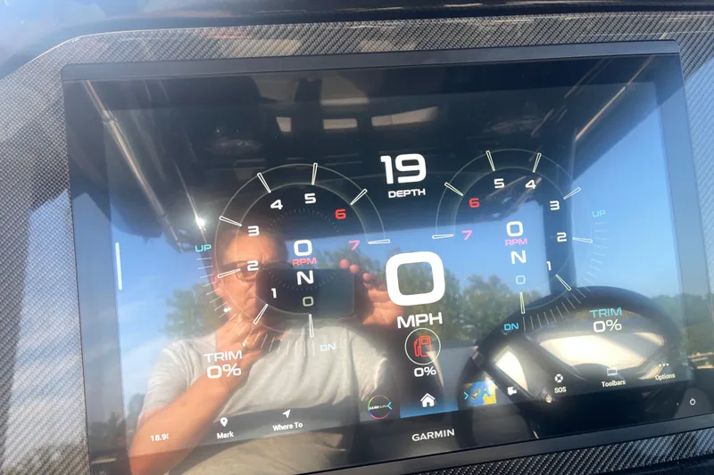 Slide: The Image of Dashboard of 2023 Nor-Tech 390 Sport boat with Garmin display showing depth and speed. - 10