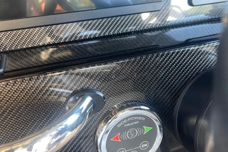 Slide: The Image of Dashboard of 2023 Nor-Tech 390 Sport with carbon fiber finish and thruster control. - 11