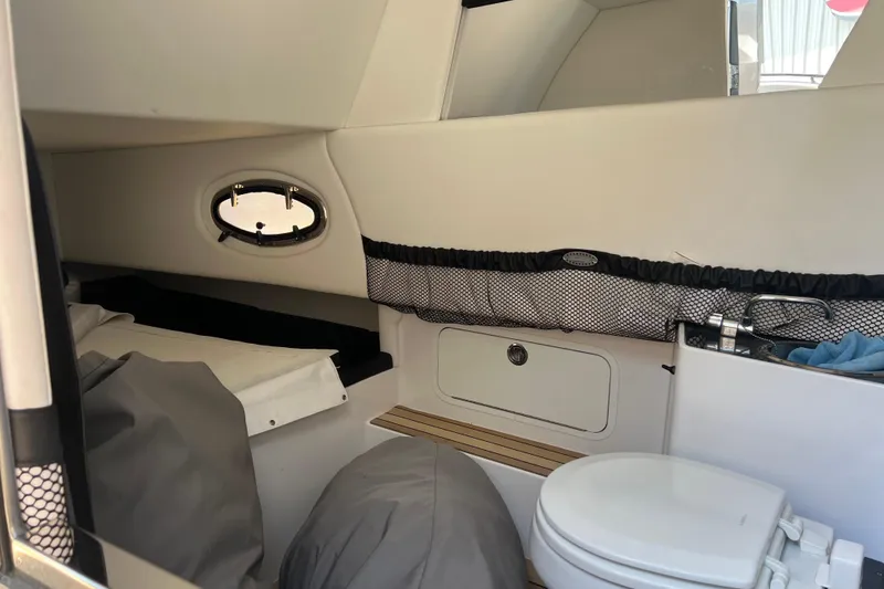 Slide: The Image of 2023 Nor-Tech 390 Sport cabin interior with compact toilet and storage. - 12