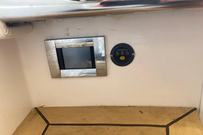 Slide: The Image of 2023 Nor-Tech 390 Sport interior with control panel and wooden flooring. - 13