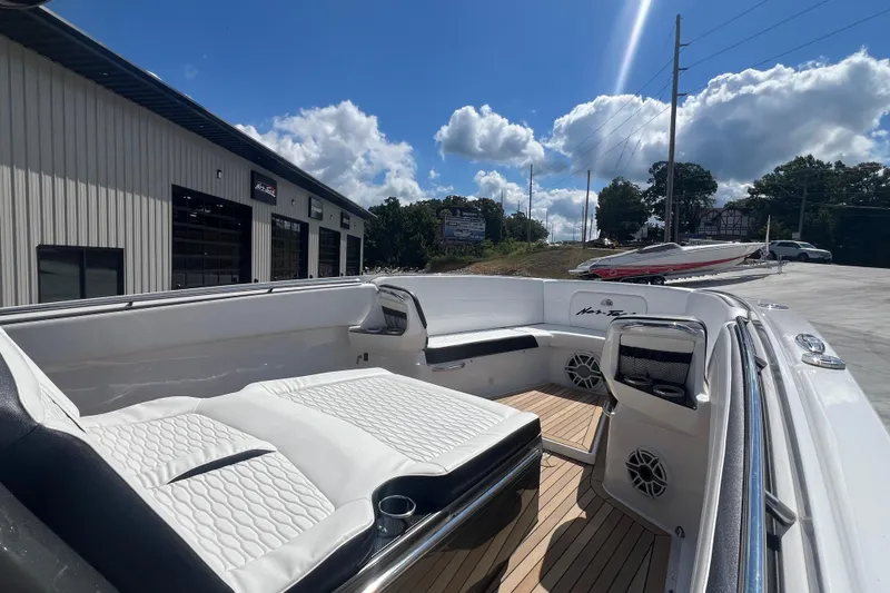 Slide: The Image of 2023 Nor-Tech 390 Sport boat interior with white seating and wood flooring. - 4