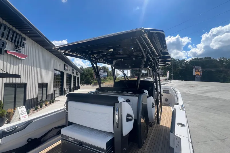 Slide: The Image of 2023 Nor-Tech 390 Sport boat at dealership under clear blue sky. - 5