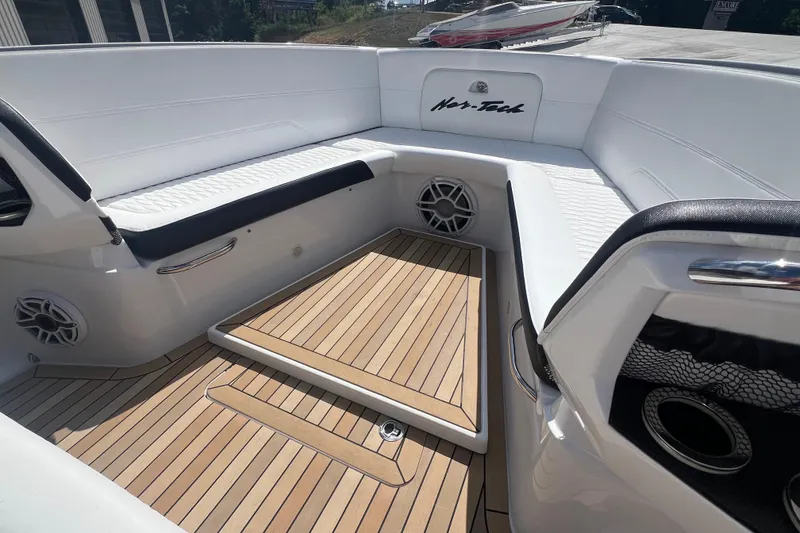 Slide: The Image of 2023 Nor-Tech 390 Sport boat interior with white seating and teak flooring. - 8