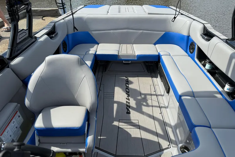 Slide: The Image of 2023 Moomba Max boat interior with gray and blue seating, spacious layout. - 10