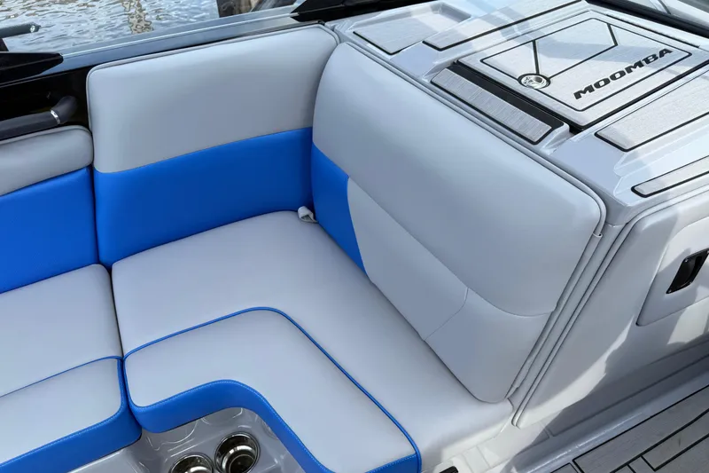Slide: The Image of 2023 Moomba Max boat interior with blue and gray seating, showcasing modern design. - 11