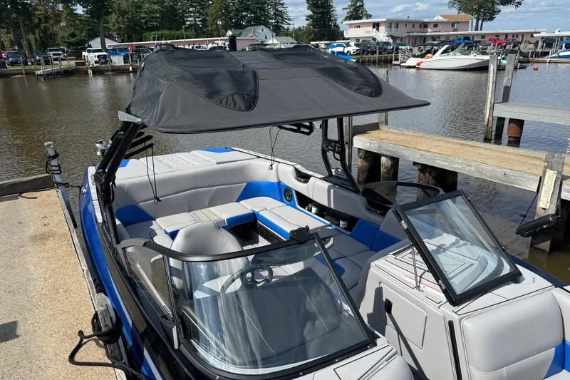 Slide: The Image of 2023 Moomba Max boat docked, featuring sleek design and spacious seating. - 6