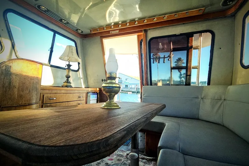 Slide: The Image of Interior of 1989 Mediterranean 38 Express yacht with wooden table and vintage lamps. - 11