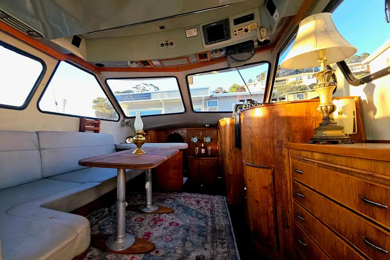 Slide: The Image of Interior of 1989 Mediterranean 38 Express yacht with cozy seating and elegant wooden furnishings. - 12