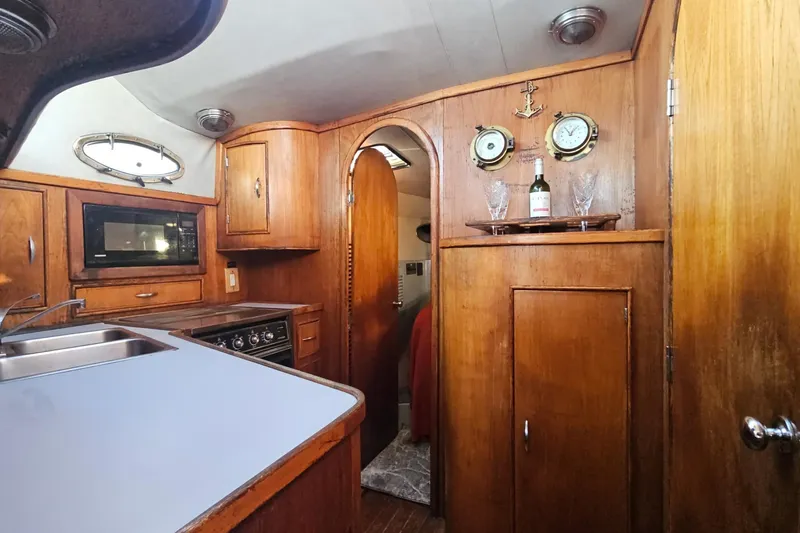 Slide: The Image of Interior of 1989 Mediterranean 38 Express yacht with wood cabinetry and modern amenities. - 15