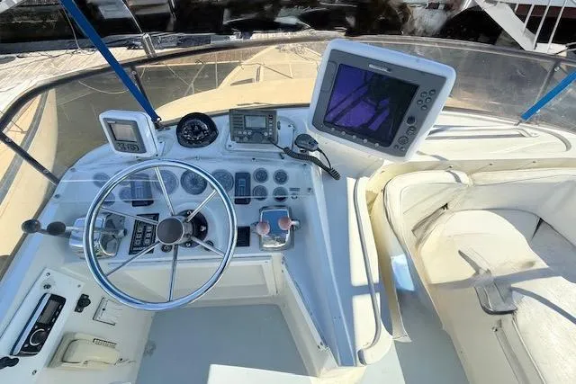 Slide: The Image of Cockpit of 1989 Mediterranean 38 Express boat with steering wheel and navigation equipment. - 5