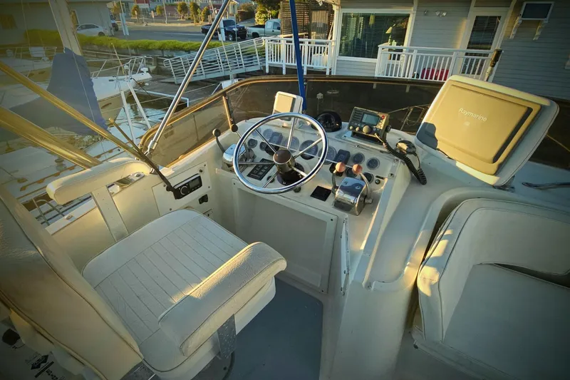 Slide: The Image of 1989 Mediterranean 38 Express boat cockpit with steering wheel and navigation equipment. - 6