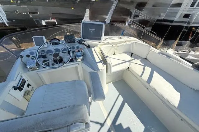 Slide: The Image of 1989 Mediterranean 38 Express boat cockpit with steering wheel and seating area. - 7