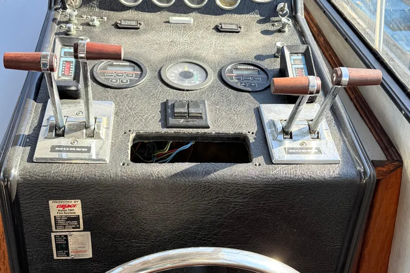 Slide: The Image of 1989 Mediterranean 38 Express boat dashboard with controls and gauges. - 8