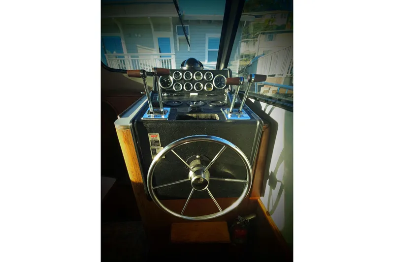 Slide: The Image of 1989 Mediterranean 38 Express boat helm with steering wheel and control panel. - 9