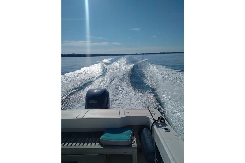 Slide: The Image of 2008 Parker 2520 Modified Vee Sport Cabin cruising on calm water, leaving a wake. - 8