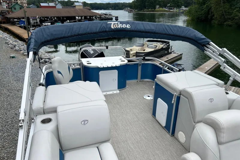 Slide: The Image of 2021 Tahoe Pontoon GT Center Console Fish 25' on a serene lake dock. - 12