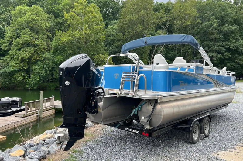 Slide: The Image of 2021 Tahoe Pontoon GT Center Console Fish 25' on trailer by lakeside dock. - 2