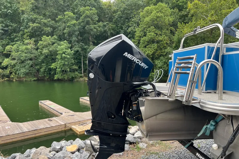 Slide: The Image of 2021 Tahoe Pontoon GT Center Console Fish 25' with Mercury outboard engine by a dock. - 3