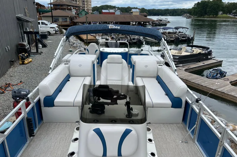 Slide: The Image of 2021 Tahoe Pontoon GT Center Console Fish 25' docked at a scenic lakeside marina. - 7