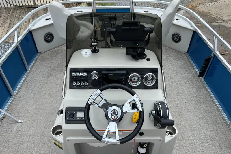 Slide: The Image of 2021 Tahoe Pontoon GT Center Console Fish 25' boat dashboard with steering wheel and controls. - 9