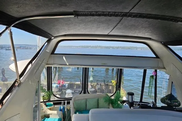 Slide: The Image of 2003 Carver 444 Cockpit Motor Yacht interior with helm, seating, and windows. - 12