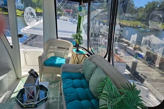 Slide: The Image of 2003 Carver 444 Cockpit Motor Yacht interior with plush seating and decorative pillows. - 13