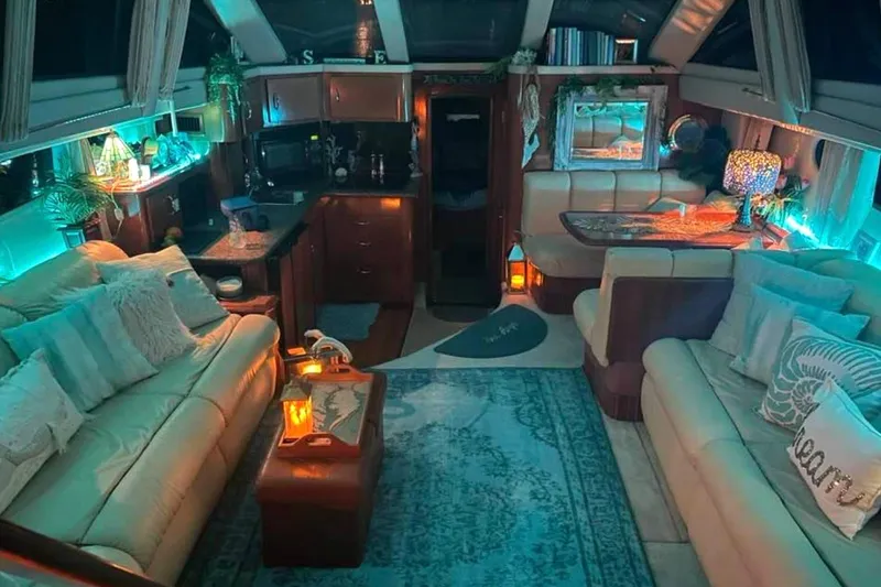 Slide: The Image of 2003 Carver 444 Cockpit Motor Yacht interior with wicker seating and turquoise cushions. - 16