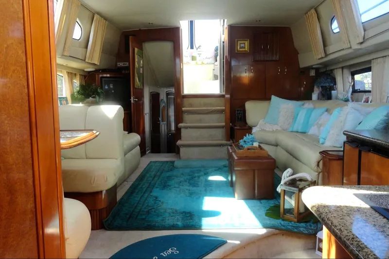 Slide: The Image of Interior view of 2003 Carver 444 Cockpit Motor Yacht overlooking serene waterfront. - 17