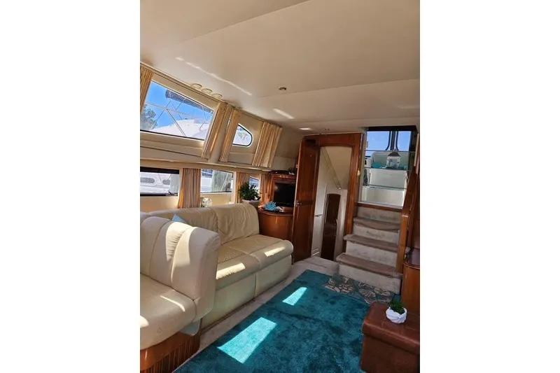 Slide: The Image of Luxurious interior of 2003 Carver 444 Cockpit Motor Yacht with ambient lighting and plush seating. - 21