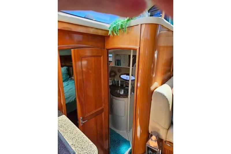 Slide: The Image of Interior of 2003 Carver 444 Cockpit Motor Yacht with cozy seating and kitchenette. - 24