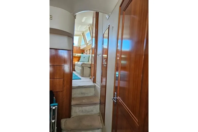 Slide: The Image of Interior of 2003 Carver 444 Cockpit Motor Yacht with cozy seating and natural light. - 25