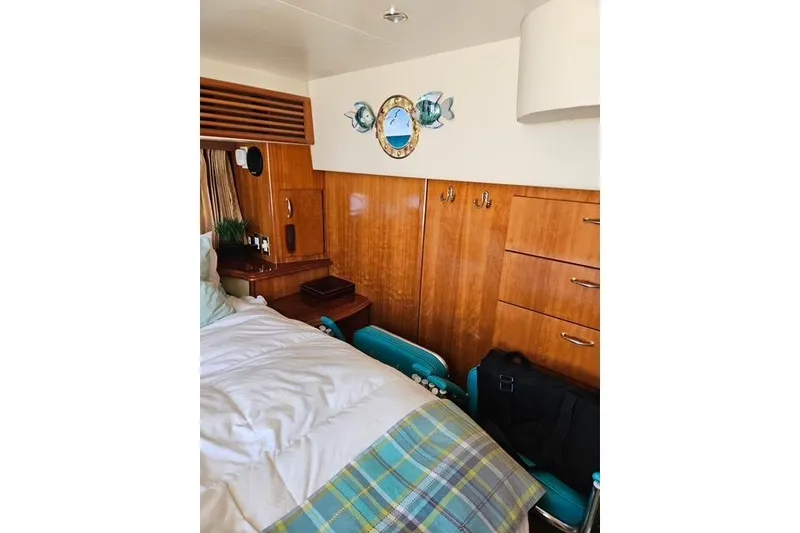 Slide: The Image of Interior of 2003 Carver 444 Cockpit Motor Yacht with wooden stairs and seating area. - 28