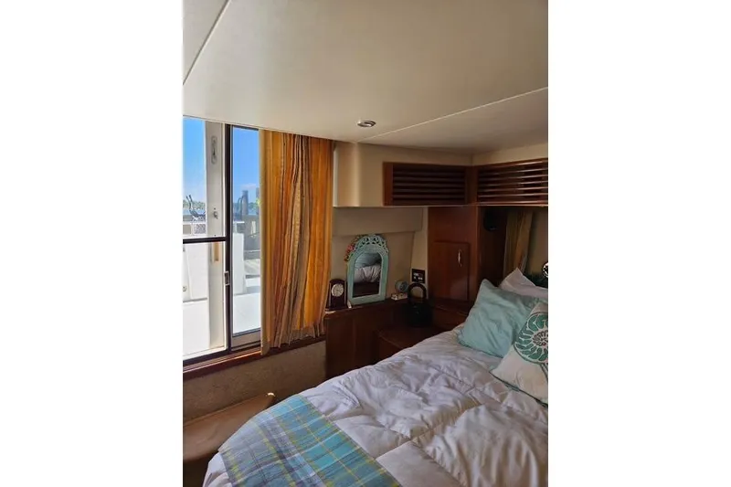 Slide: The Image of Interior view of 2003 Carver 444 Cockpit Motor Yacht, featuring wooden finishes and carpeted stairs. - 29