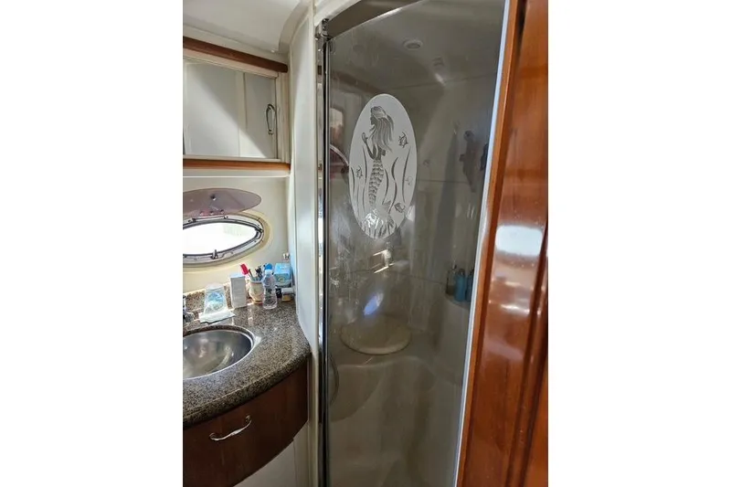 Slide: The Image of Interior of 2003 Carver 444 Cockpit Motor Yacht with wooden cabinetry and cozy furnishings. - 30