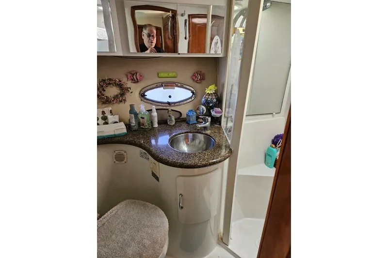 Slide: The Image of Interior view of 2003 Carver 444 Cockpit Motor Yacht with wooden finishes and cozy seating. - 31