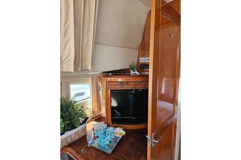 Slide: The Image of Interior of 2003 Carver 444 Cockpit Motor Yacht with cozy cabin and wooden finishes. - 32