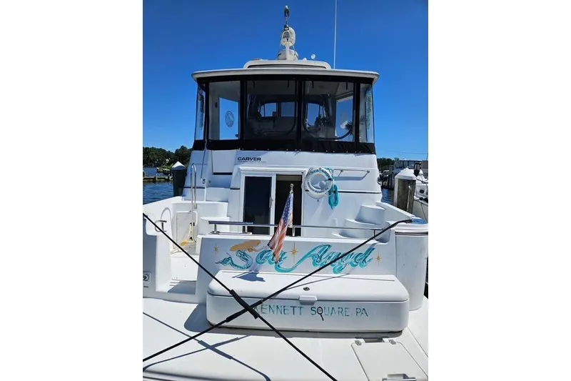 Slide: The Image of 2003 Carver 444 Cockpit Motor Yacht cruising on a calm lake. - 4