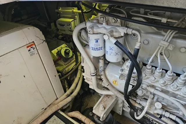 Slide: The Image of Engine room of 2003 Carver 444 Cockpit Motor Yacht with visible Volvo components. - 43