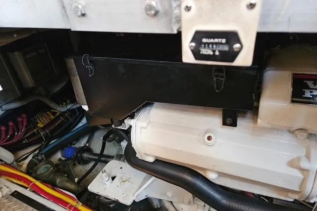 Slide: The Image of Engine compartment of a 2003 Carver 444 Cockpit Motor Yacht, showcasing mechanical components. - 44