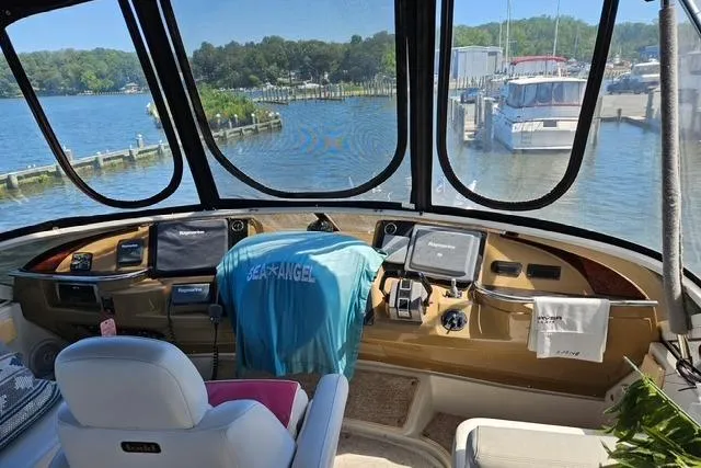 Slide: The Image of Steering console of 2003 Carver 444 Cockpit Motor Yacht with gauges and controls. - 7