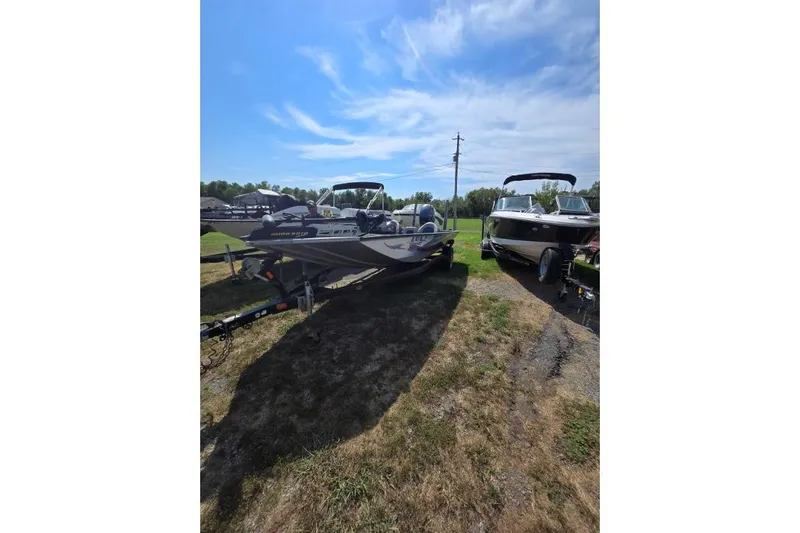 Slide: The Image of 2014 G3 Eagle Talon 19 DLX boat on trailer, parked outdoors under blue sky. - 1