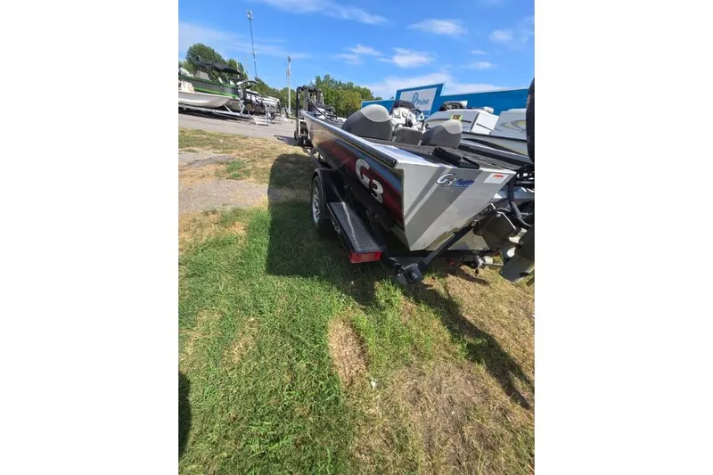 Slide: The Image of 2014 G3 Eagle Talon 19 DLX boat on trailer, parked on grass. - 10