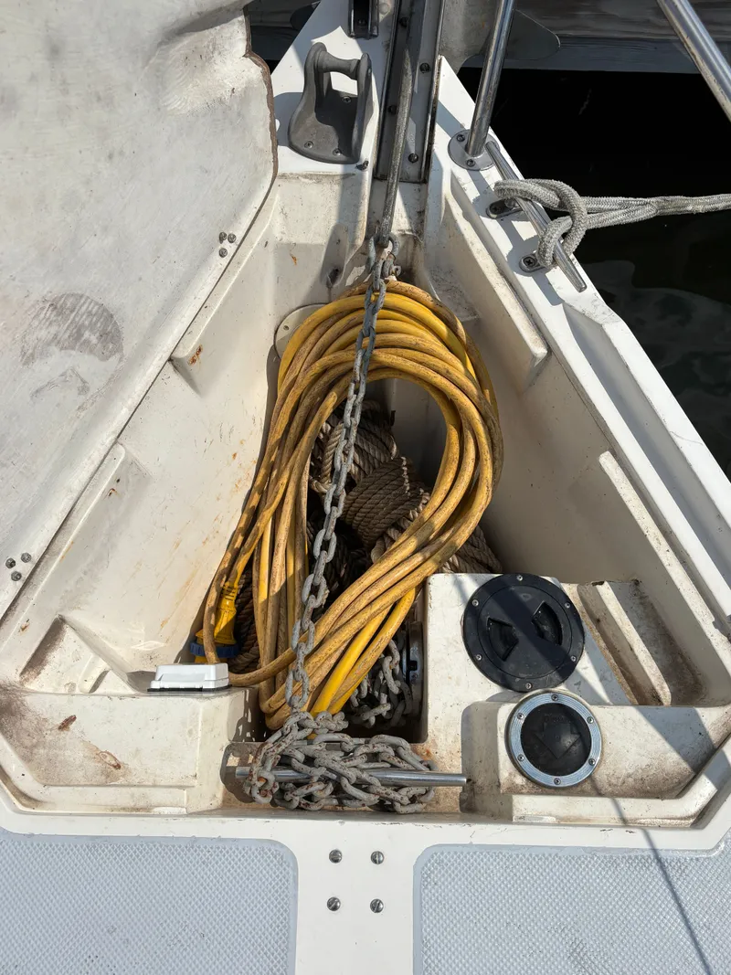 Slide: The Image of Anchor locker of a 1992 Catalina 34 sailboat with yellow hose and chain. - 11