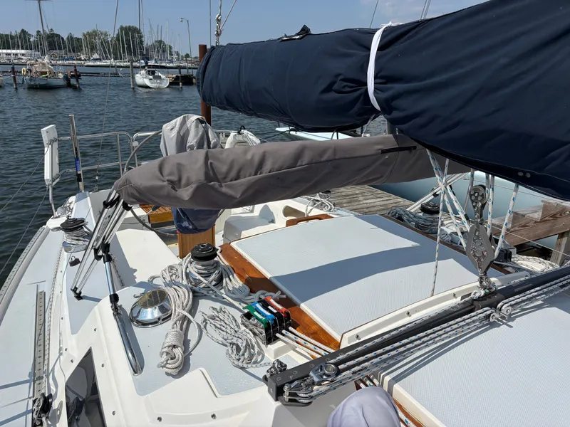 Slide: The Image of 1992 Catalina 34 sailboat deck with rigging and covered boom in a marina. - 15