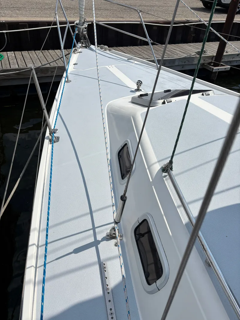 Slide: The Image of Deck view of a 1992 Catalina 34 sailboat docked at a marina. - 18