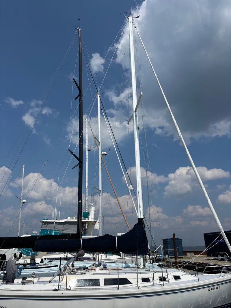 Slide: The Image of Sailboat Catalina 34, 1992 model, docked under a partly cloudy sky. - 2