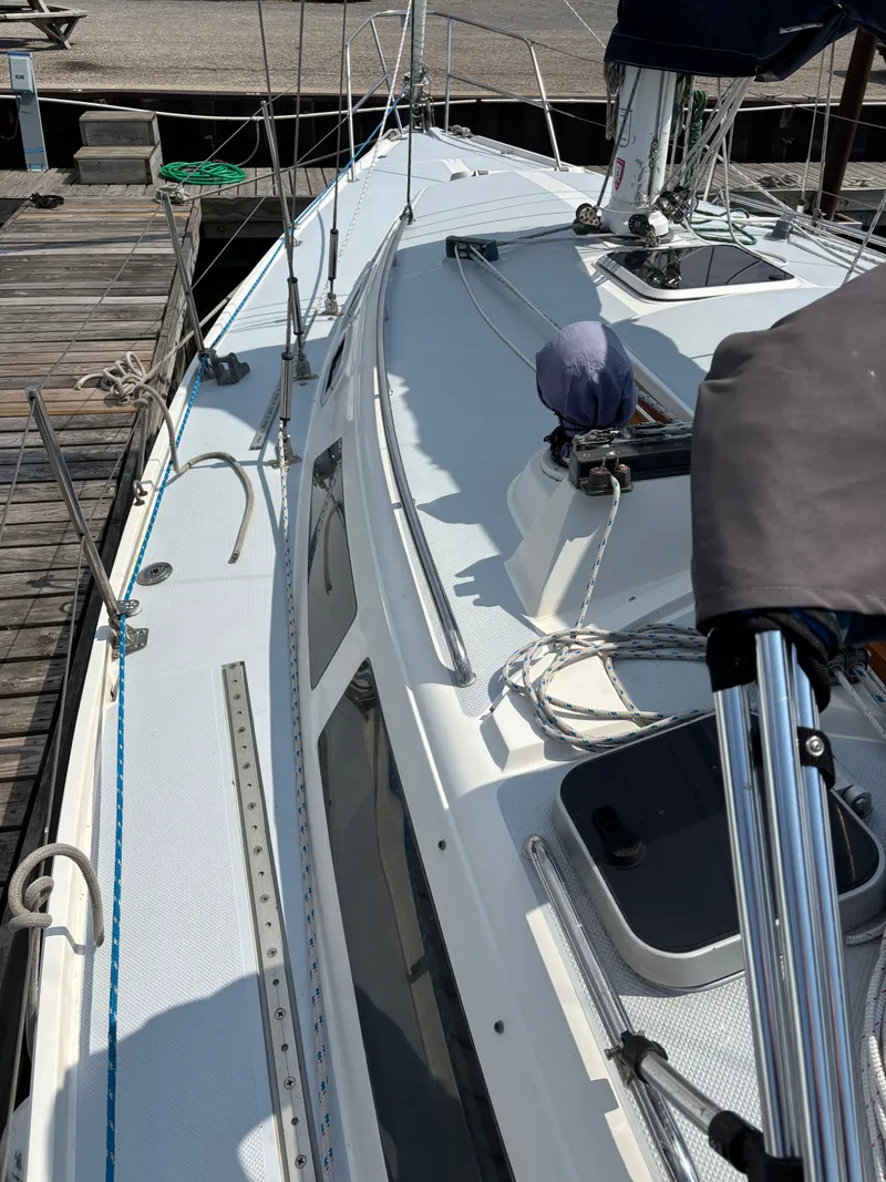 Slide: The Image of 1992 Catalina 34 sailboat deck view at dock, showcasing rigging and hatches. - 20