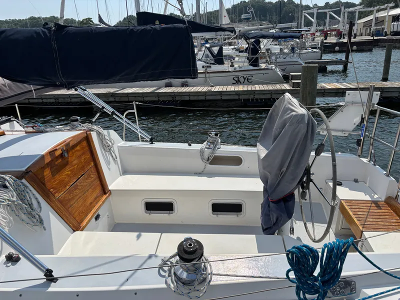 Slide: The Image of 1992 Catalina 34 sailboat cockpit with covered wheel, docked in marina. - 23
