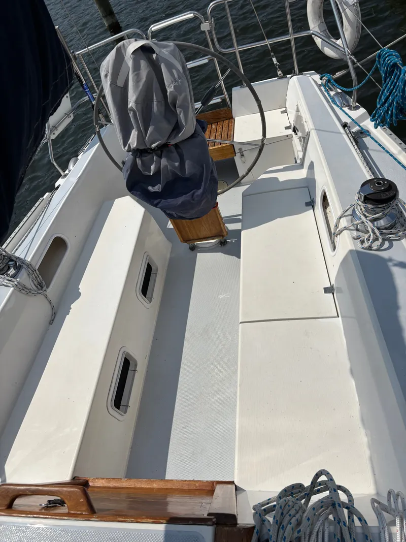 Slide: The Image of Cockpit of a 1992 Catalina 34 sailboat with covered steering wheel and seating. - 24